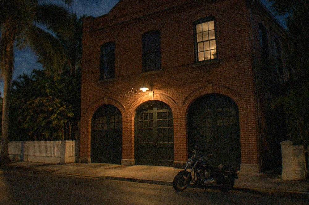 An old firehouse facade with original brickwork at night