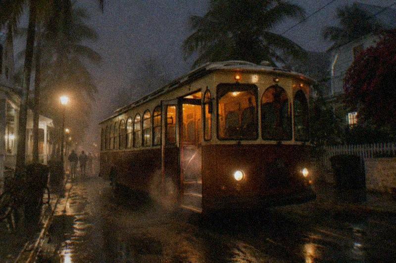 Nighttime trolley tour passing old Key West streets