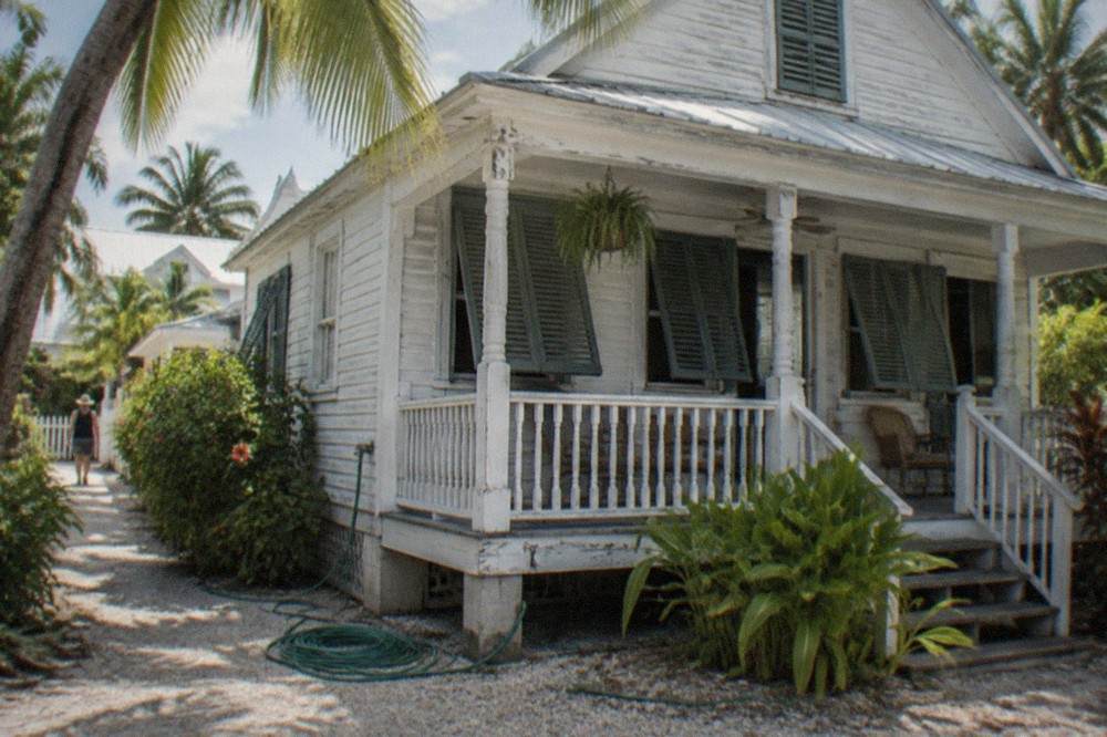 Historic conch-style wooden house in Key West Old Town with shutters and porch