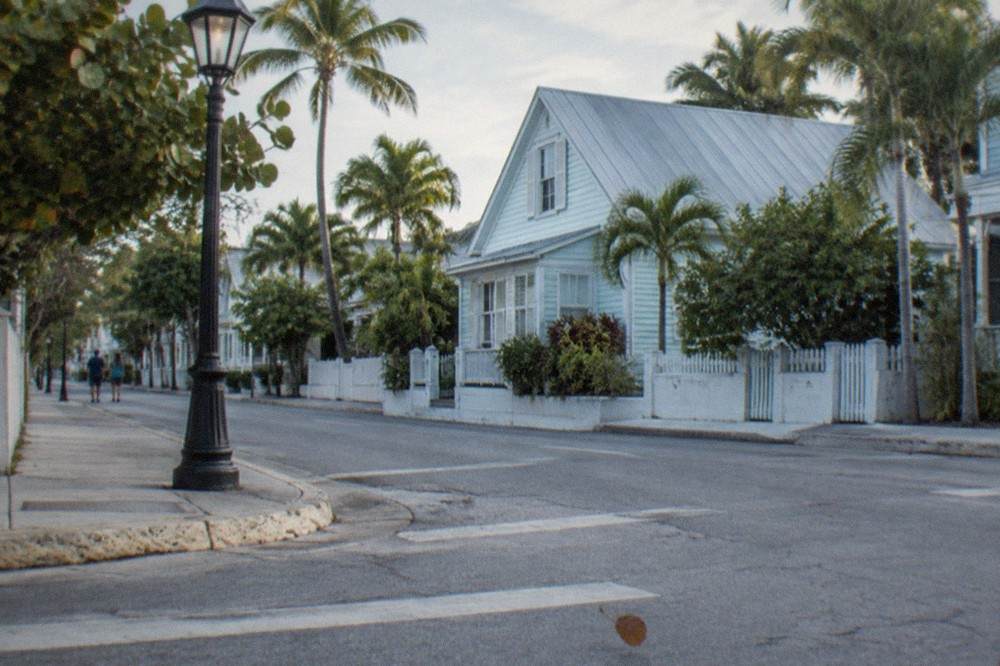 A darkened Key West street corner lit by a single streetlamp