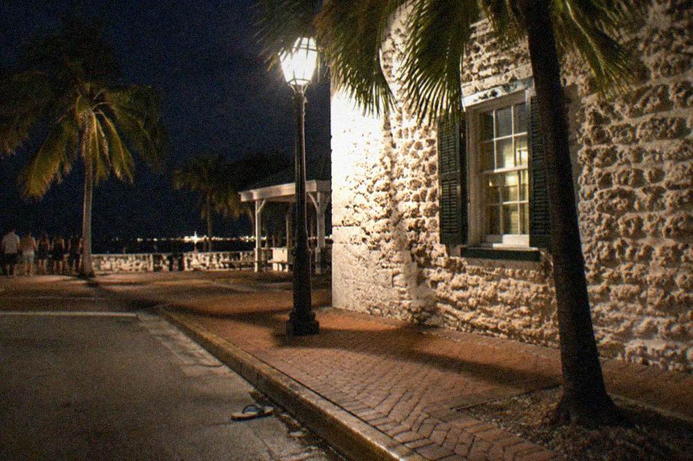 A lantern-lit historic Key West street corner at night