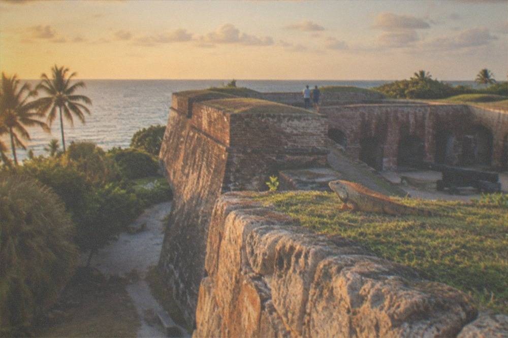 A brick Civil War fort wall and ramparts under an evening sky