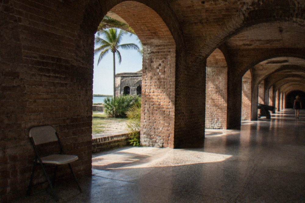 Sunlit brick archway inside a Civil War fort museum corridor