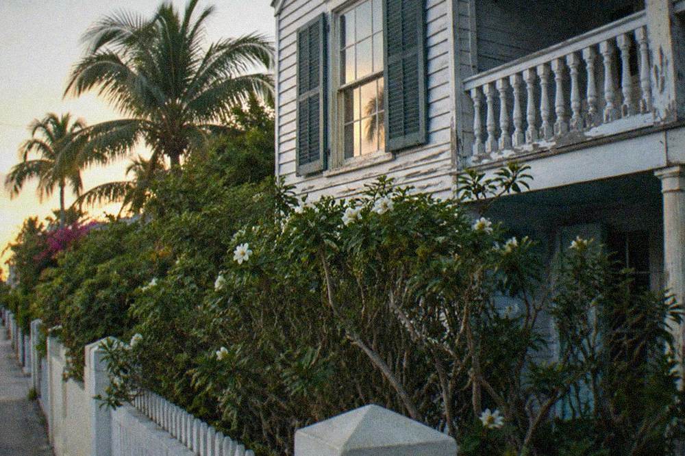 Exterior of a historic Key West house with a second-story window