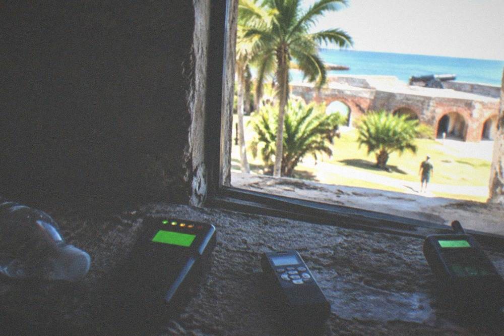 Ghost-hunting equipment resting on a stone ledge in a dark room